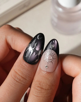 Arcana press on nails with sculpted silver sun, moon, star and key charms and a silver wing on plum and black cat eye with crystals - image 4