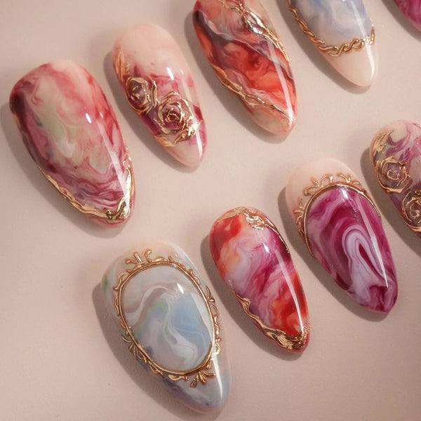 Artistic red marble press-on nails with gold frame