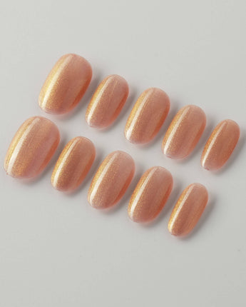 Aurora Flame press-on nails in short oval shape — orange & gold cat eye