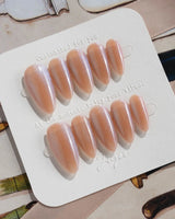 Aurora Icefire press-on nails in medium almond shape — Icy Iridescent Cat Eye.