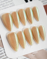 Aurora Mist press-on nails in medium stiletto shape — Champagne Nude, Green Aurora Cat Eye.