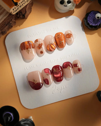 Autumn Bounty press-on nails with raised fruit details, gold outlines and nude base