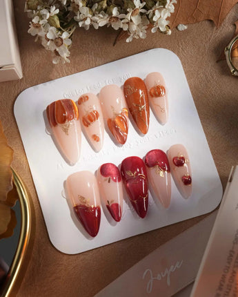 Autumn Bounty press-on nails with dimensional pumpkin, apple and soft nude gel styling