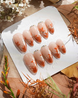 Amber Maple handmade press-on nails featuring orange french tips gold outline maple leaves