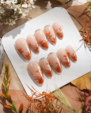 Amber Maple handmade press-on nails featuring orange french tips gold outline maple leaves