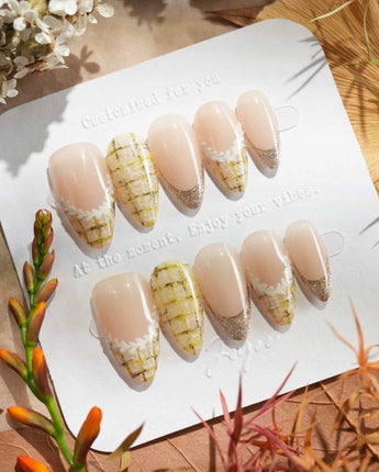 Tweed Light nail set with pale nude base, gold shimmer tips, and soft plaid accents
