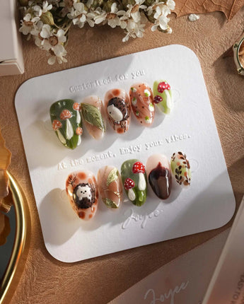 Autumn Tales press-on nails with cozy woodland scene, hedgehog accent and mushroom details