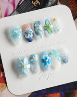 Bali Blue handmade nails with seafoam texture, blue florals, and glossy tropical mood