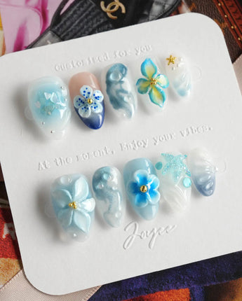 Bali Blue handmade nails with seafoam texture, blue florals, and glossy tropical mood