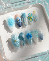 Bali Blue medium almond nails with ocean blue 3D flowers and tropical starfish details