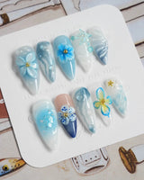 Bali Blue medium stiletto nails with sculpted ocean flowers and starfish details