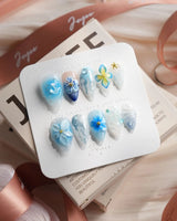 Bali Blue short stiletto nails with ocean blue flowers, starfish, and jelly shine
