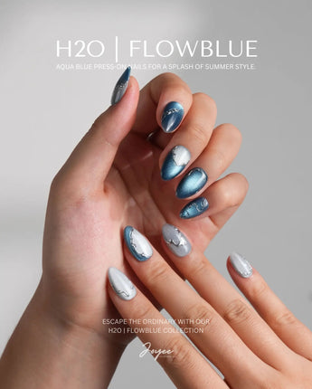 Banff Blue glossy almond nails with deep turquoise cat-eye and icy silver detail