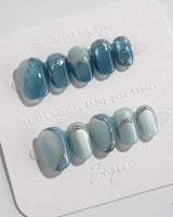 Banff Blue press-on nails in extra short oval shape — Cat Eye Blue Nails with Chrome Outline