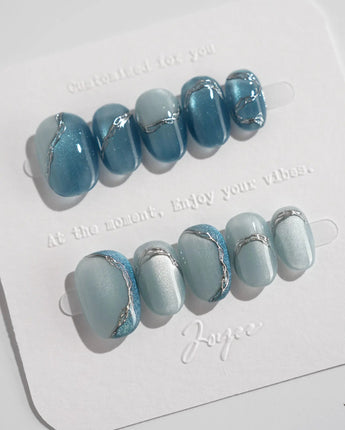 Banff Blue extra short oval nails with magnetic cat-eye blue and icy gradient