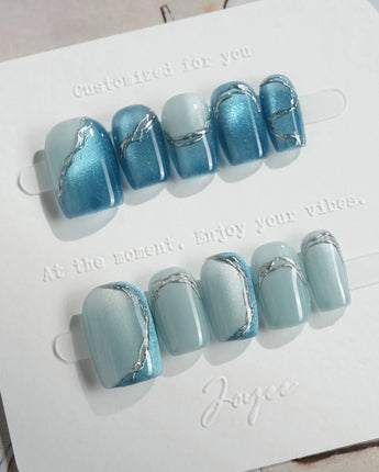 Banff Blue extra short square nails with icy cat-eye polish and chrome edges