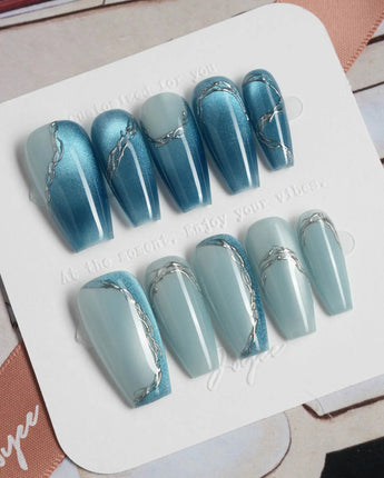 Banff Blue medium coffin nails with cat-eye blue gradient and crisp chrome edging
