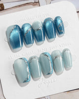 Banff Blue press-on nails in short coffin shape — Cat Eye Blue Nails with Chrome Outline