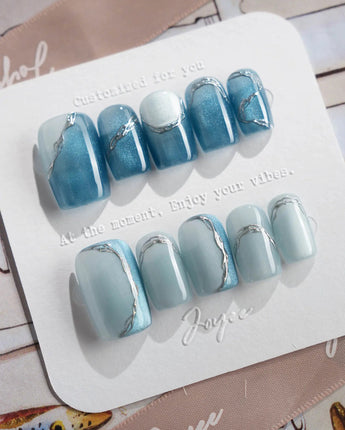 Banff Blue short square nails with turquoise cat-eye glow and silver chrome trim