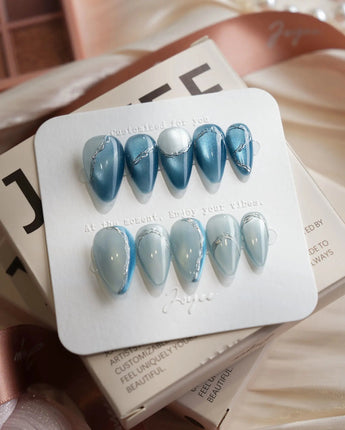Banff Blue short stiletto nails with magnetic blue chrome and glacial lake shimmer