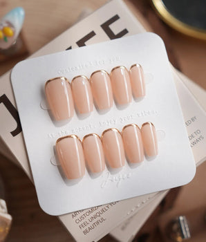 Bare Skin press-on nails in short coffin shape — Minimalist Nude Chic, Champagne Gold Cuticle Outlines.
