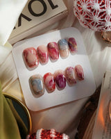 Baroque Palette press-on nails with pink-red marble swirls, gold outlines and glossy finish