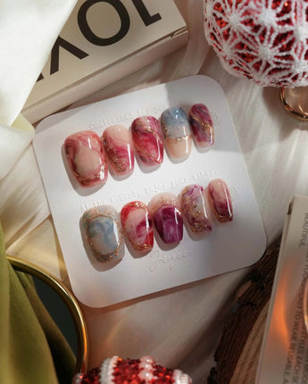 Baroque Palette press-on nails with pink-red marble swirls, gold outlines and glossy finish