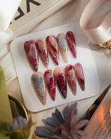 Baroque Palette press-on nails with oil-paint marble colors and baroque rose details