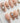 Baroque Pearl S press-on nails in medium almond with pearl accents and moonstone gems