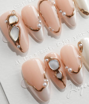 Baroque Pearl S press-on nails in medium almond with pearl accents and moonstone gems