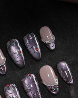 Belladonna press on nails with hand-painted dark lilies in silver outline on violet grey cat eye and nude nails edged in silver beads - image 1