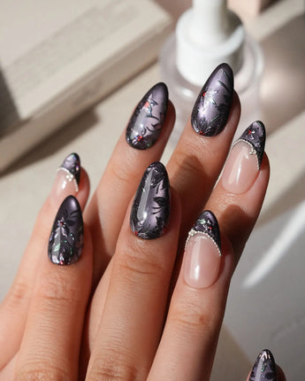 Belladonna press on nails with hand-painted dark lilies in silver outline on violet grey cat eye and nude nails edged in silver beads - image 2