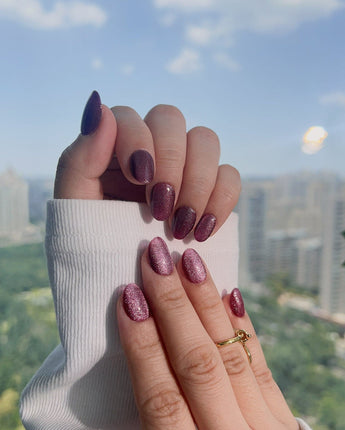 Ruby Red Cat-eye nails with dark ruby shimmer, gel shine, and dramatic fall color