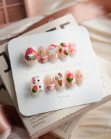 Berry Kitty extra short oval nails with strawberry cat charm and sweet fruit nail art
