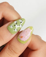 Berry Matcha glossy summer nails with matcha green, strawberry pink, and daisy details