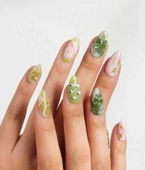 Berry Matcha iced drink press-on nails with daisies, flower accents, and gold flecks