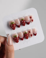 Berry me close-up of red strawberry nail art with pearl accents and glossy gel