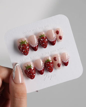 Berry me close-up of red strawberry nail art with pearl accents and glossy gel