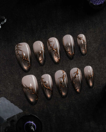 Black Briar press on nails with a nude to black cat eye ombre and raised gold thorn branches - image 2