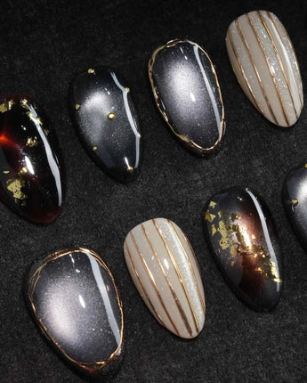 Black Lacquer press on nails with real gold foil in deep amber red and glossy black, gold studs and fine gold pinstripes on cream - image 1