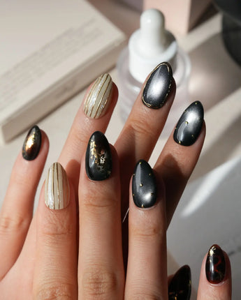 Black Lacquer press on nails with real gold foil in deep amber red and glossy black, gold studs and fine gold pinstripes on cream - image 2