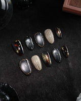 Black Lacquer press on nails with real gold foil in deep amber red and glossy black, gold studs and fine gold pinstripes on cream - image 3