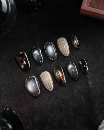 Black Lacquer press on nails with real gold foil in deep amber red and glossy black, gold studs and fine gold pinstripes on cream - image 3