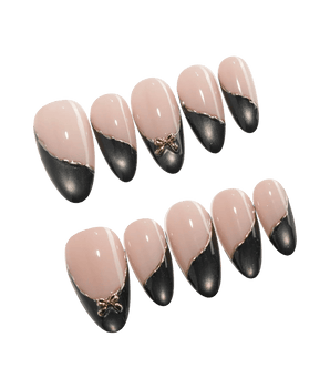 Black Tie press on nails with a black cat eye French tip edged in a fine gold line and a sculpted gold bow on a nude base - image 2