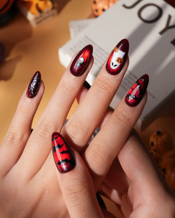 Blood Moon press on nails with black bats, bare trees, a ghost holding a pumpkin and a silver glitter spider on deep red cat eye - image 2