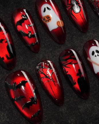 Blood Moon press on nails with black bats, bare trees, a ghost holding a pumpkin and a silver glitter spider on deep red cat eye - image 1