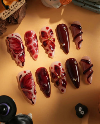 Bloody Kiss handmade press-on nails featuring deep red marble nude base 3D flower chrome beads sculpted gel drip design