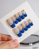 Blue French tip coffin nails with a trendy and modern shape.