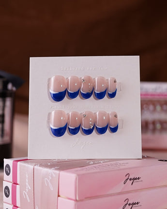 Blue French tip nails in a oval shape for a classic look.