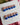 Blue French tip nails decorated with rhinestones for a glamorous look.